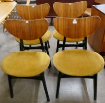 A set of four G-Plan Librenza tola wood and black butterfly-back dining chairs