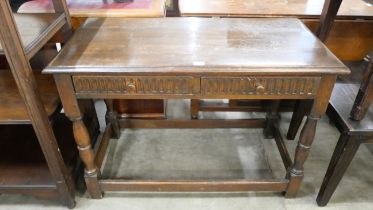 A carved oak two-drawer table