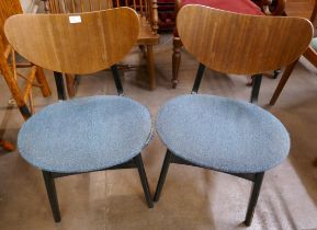 A pair of G-Plan Librenza tola wood and black butterfly-back dining chairs