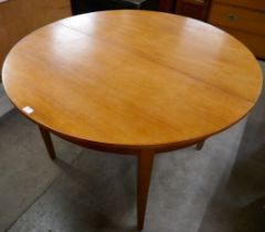 A Jnetique 513 teak circular extending dining table