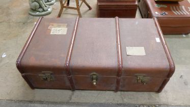 Three suitcases and a travel trunk