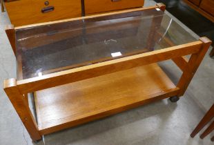 A teak and glass topped rectangular coffee table and a record cabinet