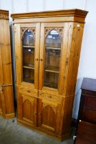 A Victorian style pine corner cabinet