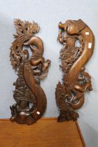 Two carved dragon plaques