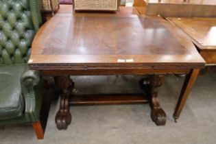 A carved oak draw-leaf table