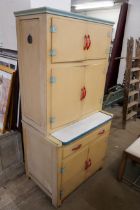 A painted cream kitchen cabinet