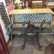 A cast iron bench, a pair of bench ends and a porch light