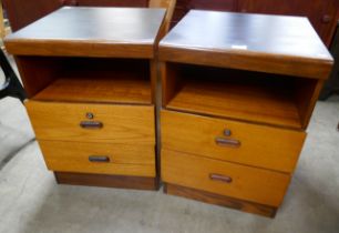 A pair of teak and black laminate bedside cabinets