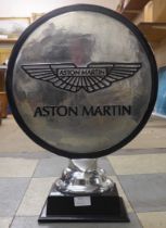 An Aston Martin motoring desk emblem