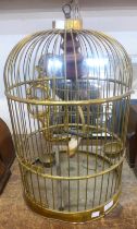 A metal bird cage with model bird