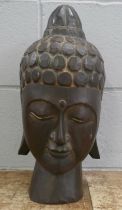 A hand carved wooden head of Buddha, 41cm