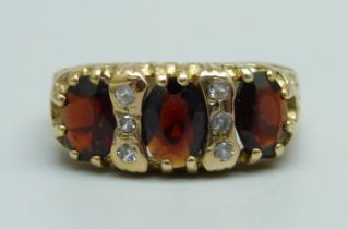 A 9ct gold, garnet and white stone ring, 3.4g, S