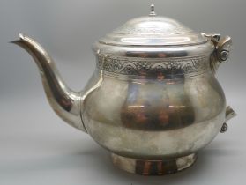 A silver teapot, lacking handle, 619g