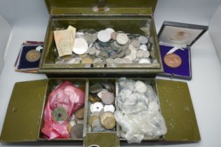 A large collection of 6d coins and other mixed coins in a cash tin