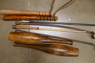 Two truncheons, a pair of Indian clubs, three riding crops and a swagger stick