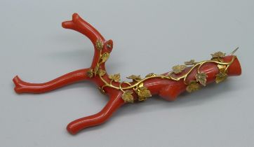 An antique yellow metal mounted stick coral brooch, tests as 15ct gold, 9.5cm, lacking one leaf