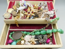 A collection of vintage costume jewellery including a white metal key brooch and an early 20th