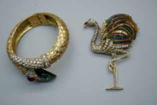 A vintage Butler & Wilson gold plated snake bracelet with diamanté detail and red and gold stones