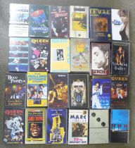 A collection of VHS video tapes including Jimi Hendrix, Spandau Ballet, Queen, Tina Turner, Genesis,