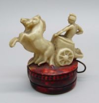 A novelty tape measure in the form of a gladiator on a chariot