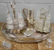 Two plated gallery trays, a water jug, a plated purse, cruets and condiments