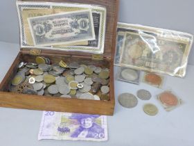 A collection of coins and pins and foreign bank notes in Vosene Shampoo promotional packaging