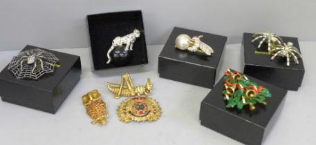 Vintage Butler & Wilson brooches; a Christmas tree with diamanté detail, a crown, a grasshopper,