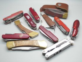 A collection of pocket knives including Victorinox