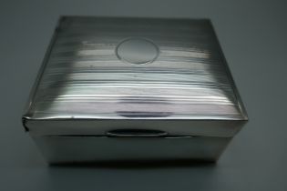 A silver cigarette box with engine turned decoration to lid, gross weight 247g, a/f (lid)