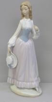 A Lladro figure of a girl with hat, lacking parasol