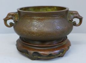 A 19th Century bronze censer on a wooden base, cast mark to base, 18cm wide including elephant