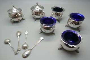 A cased six piece silver cruet set, London 1912 and four spoons, 223g