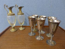A set of six Falstaff silver plated goblets and a pair of gilt brass and glass ewers