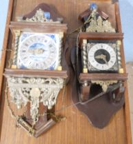 Two gilt brass and wooden hall clocks