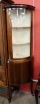 A French Empire style mahogany bow front freestanding corner cabinet