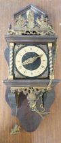 A gilt brass and wooden wall clock