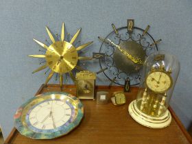 A collection of clocks including a domed clock, wall clocks, a travel clock, etc.