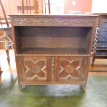 A Jacobean Revival carved oak cupboard