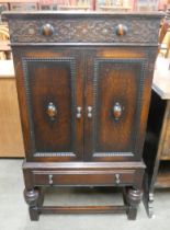 A carved oak gramophone cabinet