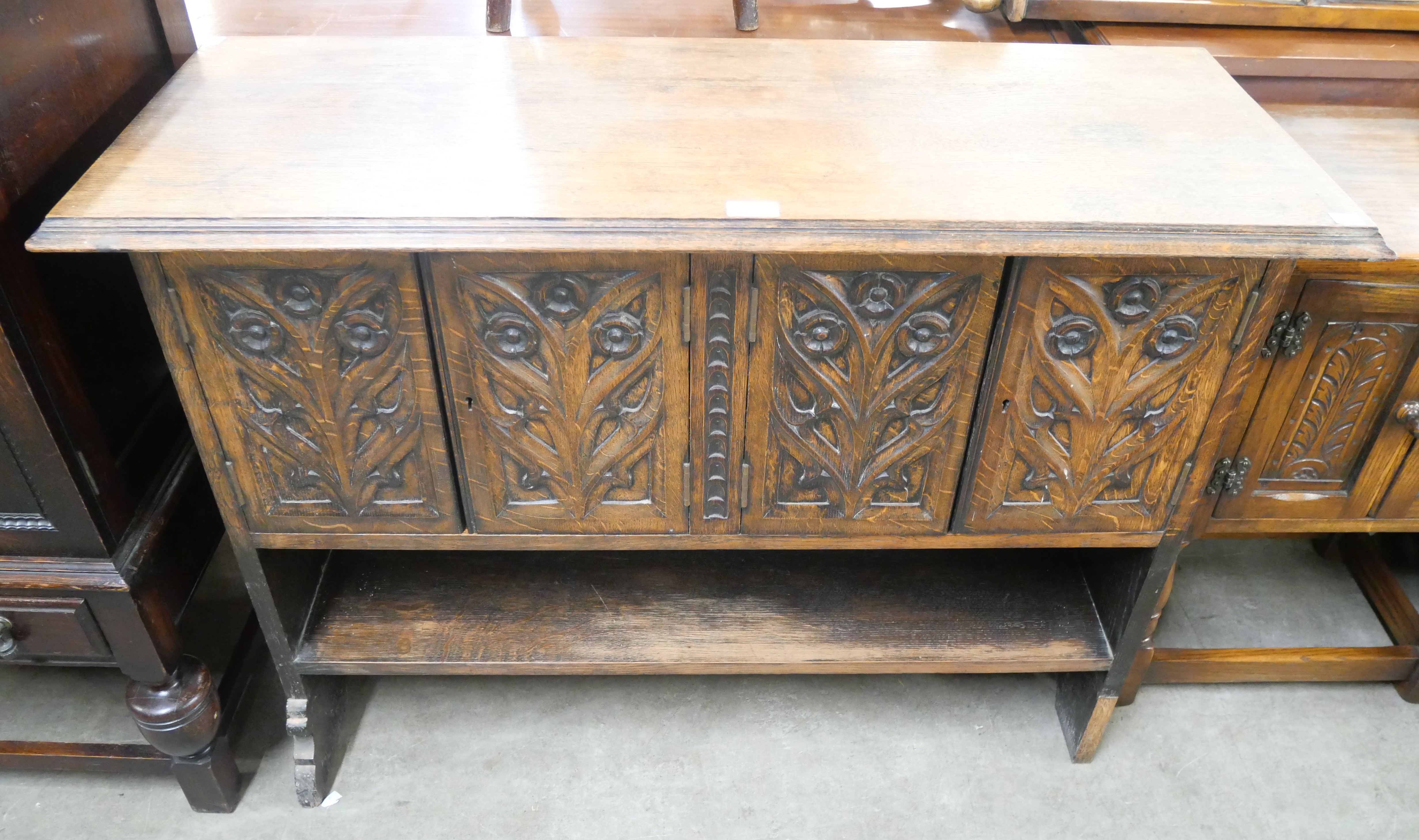 An Elizabethan Revival carved oak livery cupboard