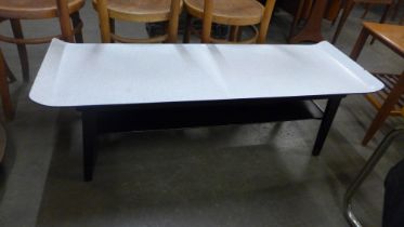 A Formica and black sleigh top coffee table