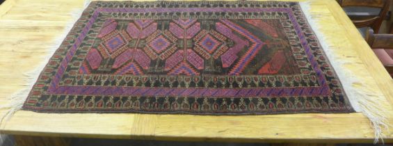 A red and blue Afghan rug, 80cm x 125cm