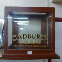 A counter top shop cabinet, bearing Cadburys inscription