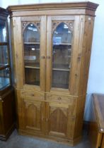 A Victorian style carved pine freestanding corner cabinet