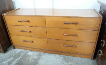 A teak chest of drawers