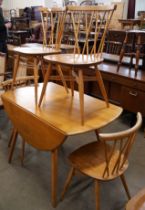 An Ercol Blonde elm and beech Windsor drop leaf table and four candlestick back chairs