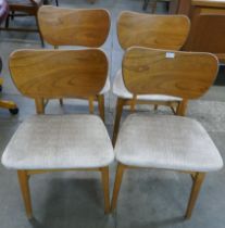 A set of four Beautility teak and elm dining chairs