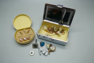 A collection of cufflinks and shirt buttons