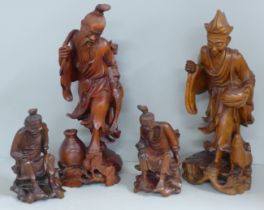 Two pairs of Chinese hardwood carved figures, tallest 31cm, one lacking staff