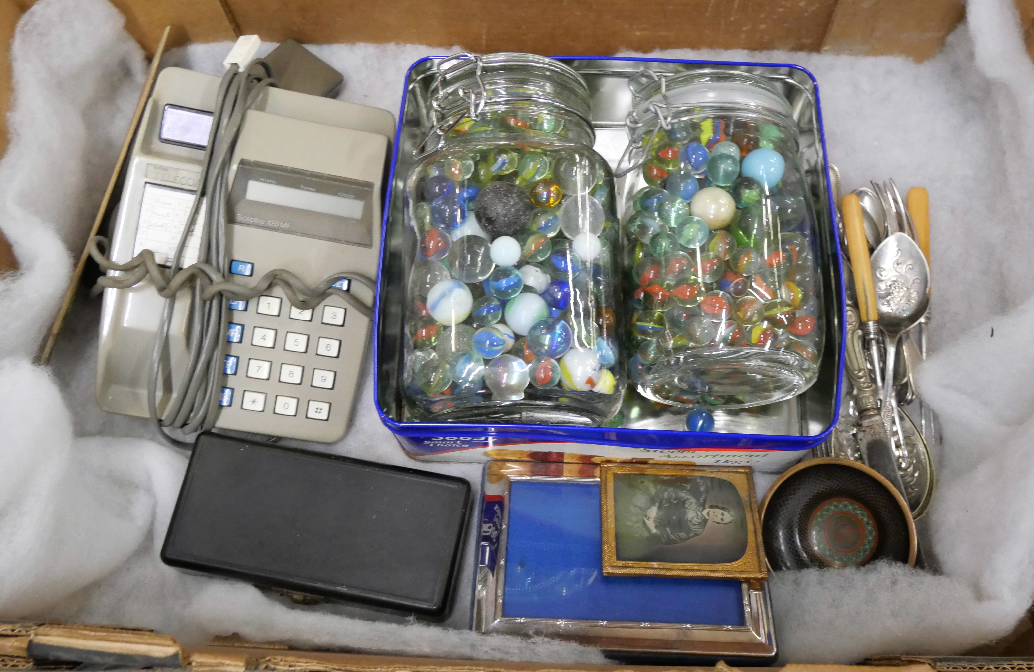 Two jars of assorted marbles, a small weights set in a Bakelite box, a British Telecom phone, silver